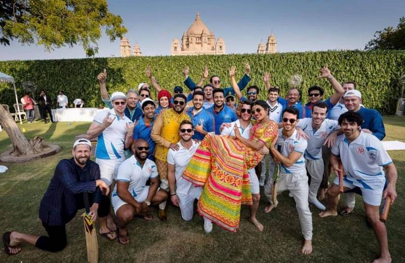 Priyanka Chopra is lifted by Nick Jonas as they pose for a photograph with others after a cricket match, a day before their wedding, at Umaid Bhawan in Jodhpur, India. Photo: Raindrop Media via AP