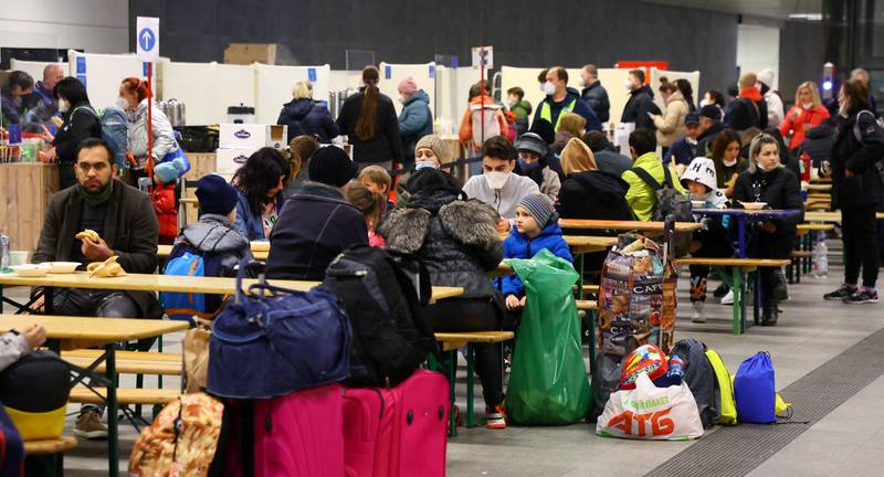 People fleeing from Ukraine eat and get some rest at a welcome centre in Berlin's Hauptbahnhof station. Reuters