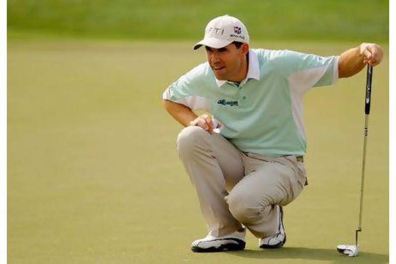 Padraig Harrington lines up a putt on the 18th green during the first round.