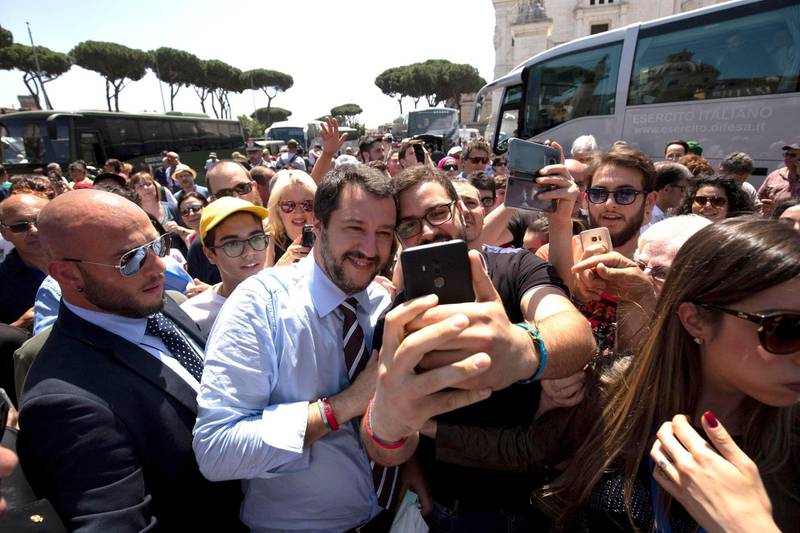 Leader of the League party and Italian Interior Minister, Matteo Salvini, poses for a photo as he walks through the crowd on the occasion of celebrations for Italy's Republic Day, in Rome Saturday, June 2, 2018. At an oath-taking ceremony in the presidential palace atop Quirinal Hill, the new premier, political novice Giuseppe Conte, and his 18 Cabinet ministers pledged their loyalty to the Italian republic and to the nation's post-war constitution in front of President Sergio Mattarella. (Claudio Peri/ANSA via AP)