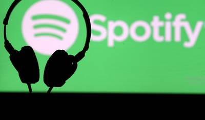 FILE PHOTO: A headset in front of a screen projection of Spotify logo, in this picture taken April 1, 2018. REUTERS/Dado Ruvic/File Photo