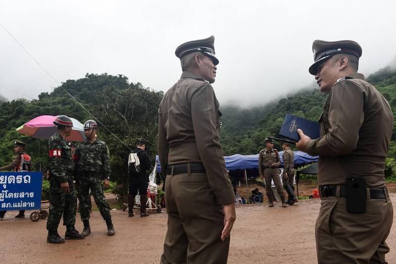 Police and soldiers guard a road leading to the Tham Luang cave area. AFP