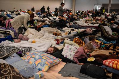 People rest at a temporary shelter for Ukrainian refugees in Przemysl, Poland. AFP