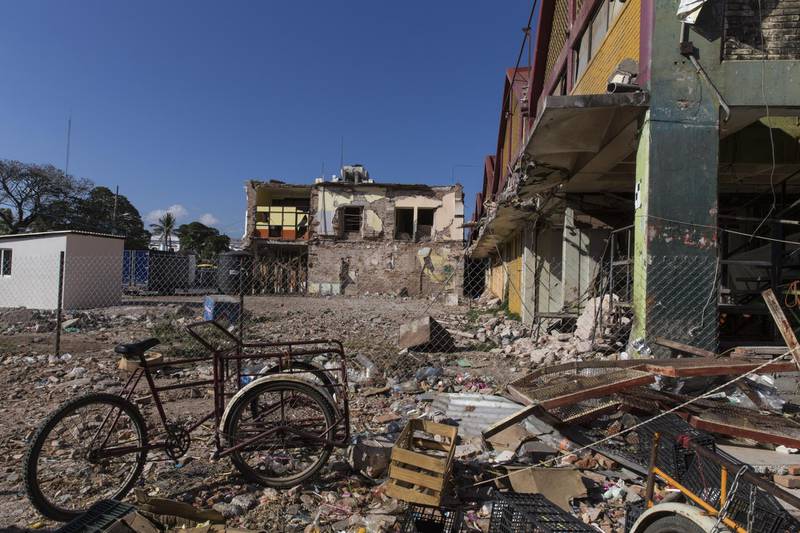 A bicycle sits in front of a market destroyed in the September earthquake in Juchitan, Oaxaca State, Mexico, on Thursday, Feb. 15, 2018. Under a program, known as Barefoot College in Tilonia, India, designed to empower poor rural communities around the world, local women from Cachimbo went to India for six months to be trained as electrical technicians. They returned to install dozens of solar panels, battery packs and wiring that now run lights and appliances all over the village. Photographer: Yael Martinez/Bloomberg