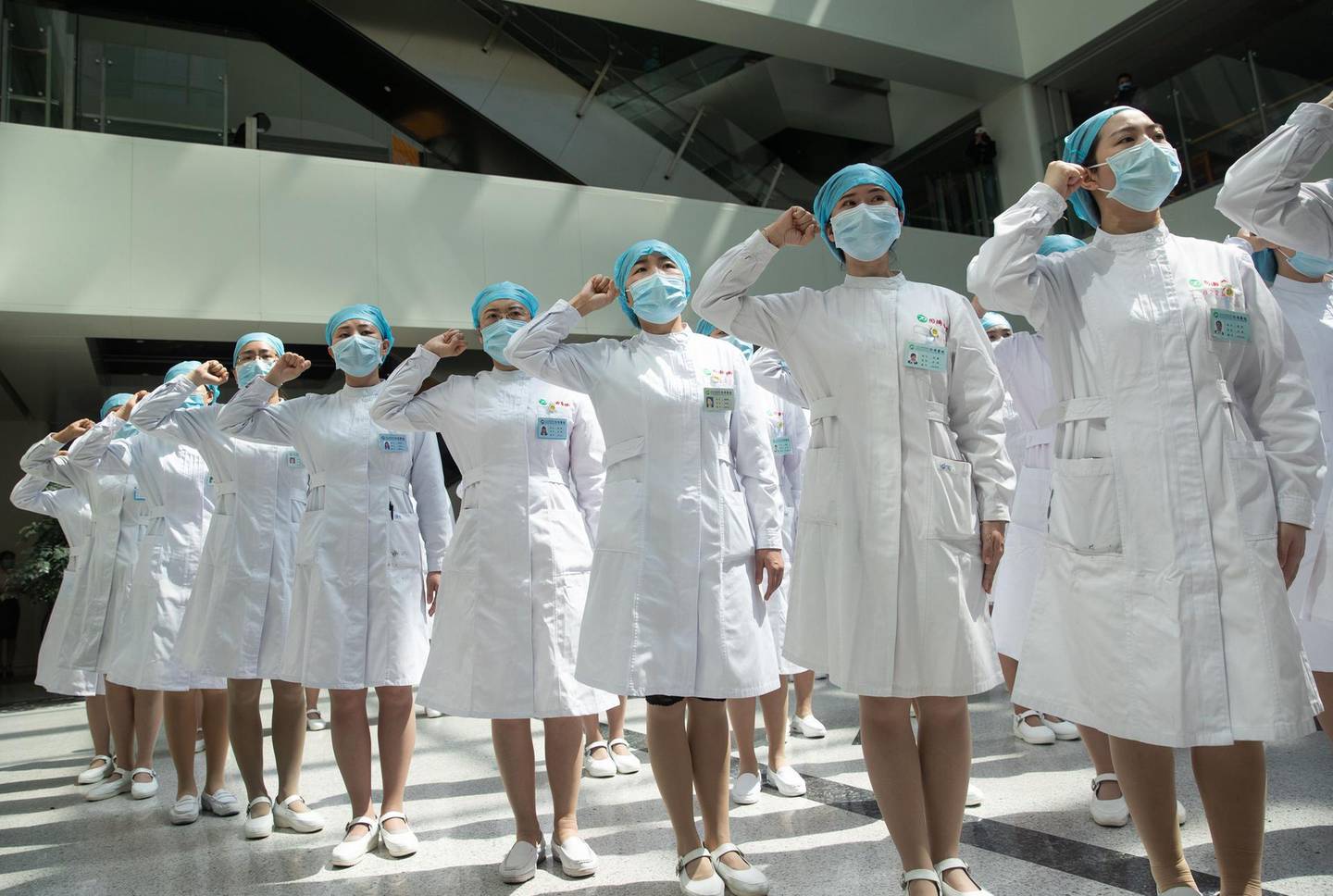 Nurses recite an oath during a ceremony marking International Nurses Day, at Tongji Hospital in Wuhan, in China's central Hubei province on May 12, 2020. As frontline hospital staff are constantly facing the risks from the COVID-19 coronavirus outbreak, the world is marking International Nurses Day, celebrated around the world every May 12, the anniversary of Florence Nightingale's birth. - China OUT
 / AFP / STR
