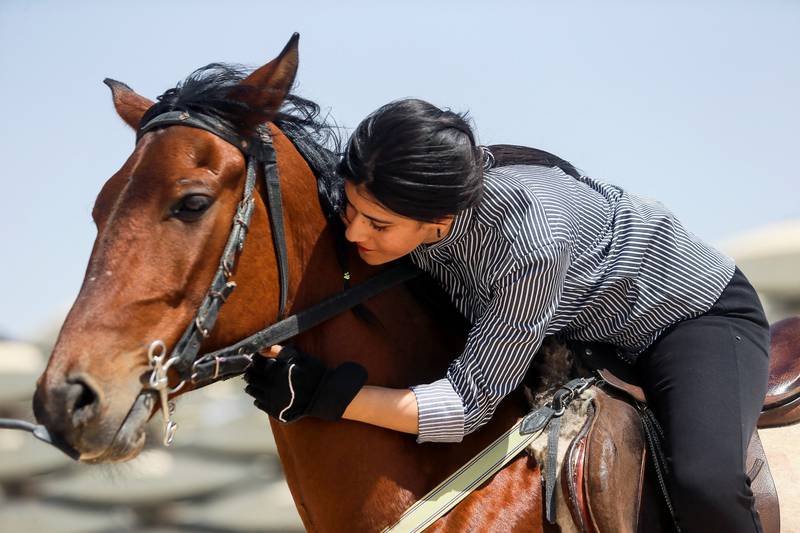 Fatima Kazem, 22, trains horses in a sport traditionally pursued in Iraq by men, at the Equestrian Club in Basra. All photos: Reuters