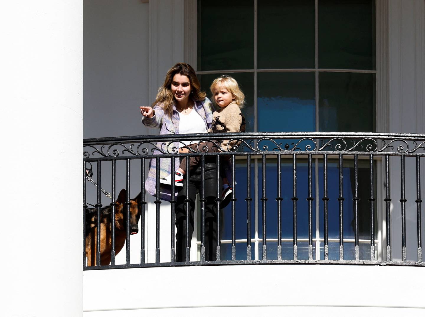 Mr Biden's granddaughter Natalie carries Beau Biden Jr as Commander the dog looks on at the Turkey pardoning. Reuters