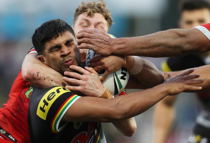 Tyrone Peachey of the Penrith Panthers is tackled by Kurt Mann of the St George Illawarra Dragons during their NRL match in Sydney. Mark Metcalfe / Getty Images