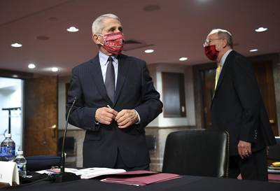 Anthony Fauci, Director of the National Institute of Allergy and Infectious Diseases, wears a Washington Nationals protective mask before a Senate Health, Education, Labor and Pensions Committee hearing in Washington this week. Bloomberg
