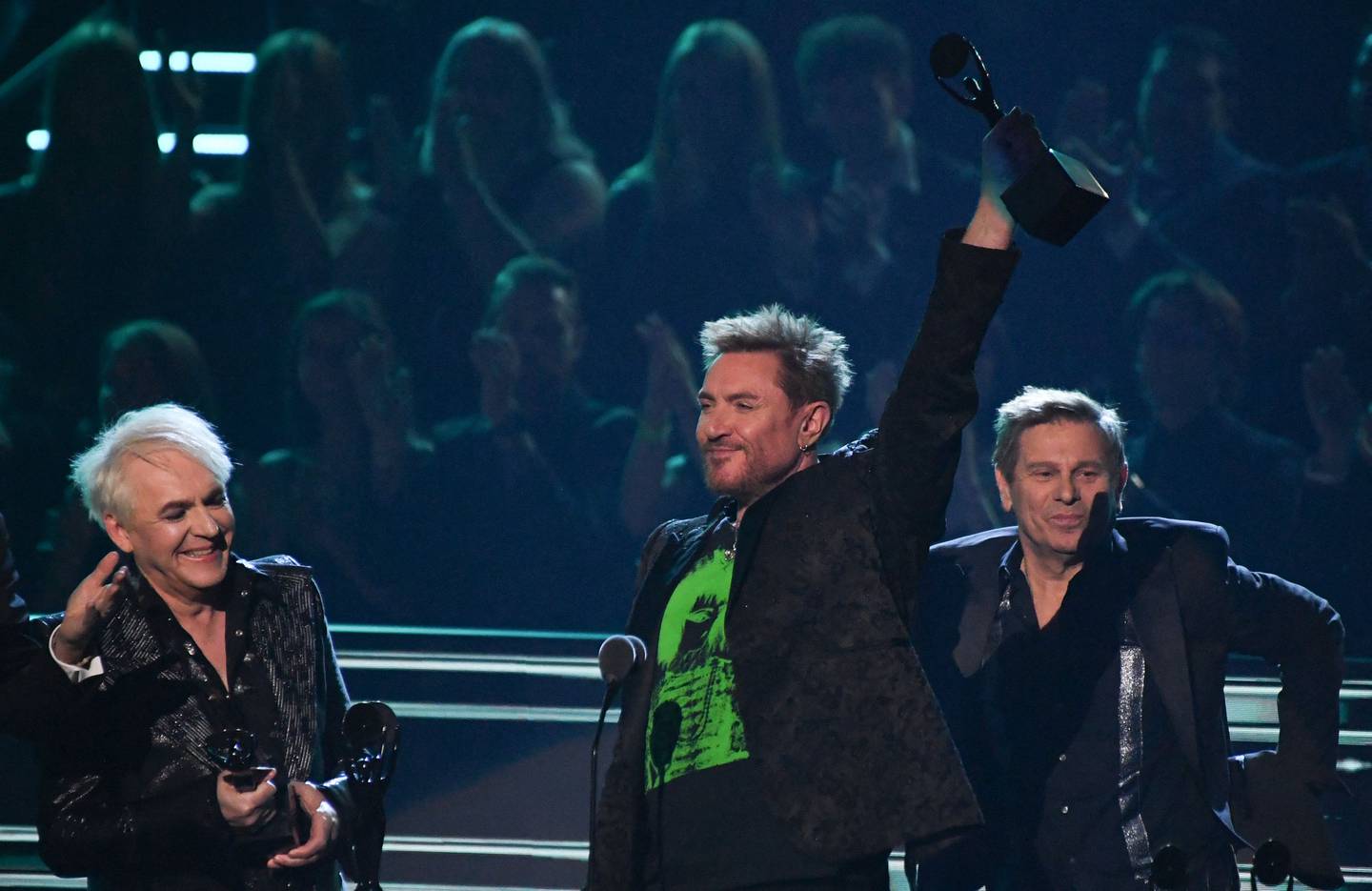 Nick Rhodes, Simon Le Bon and Roger Taylor of Duran Duran with their trophy. AFP