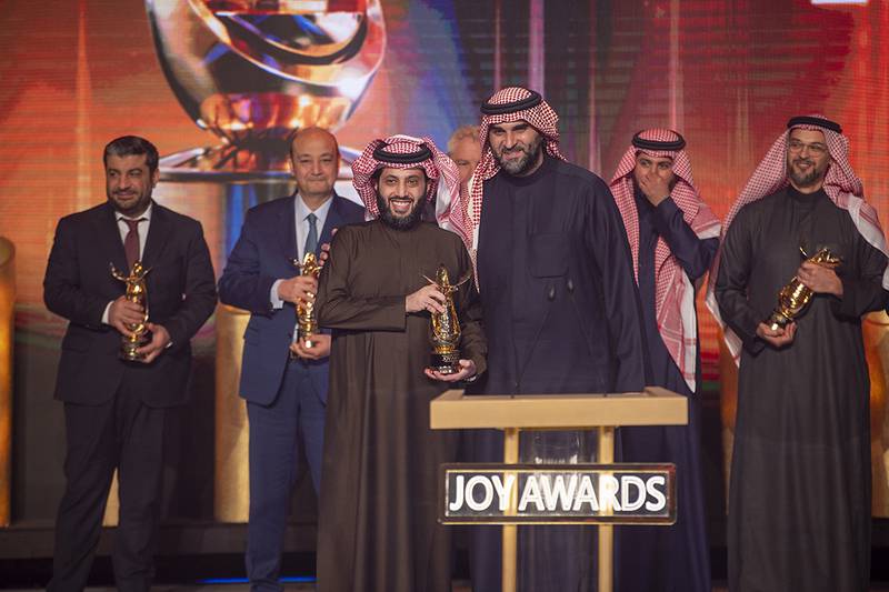  Turki Al Sheikh (centre left), chairman of the Board of Directors of General Entertainment Authority, holds a Joy Award during the ceremony.