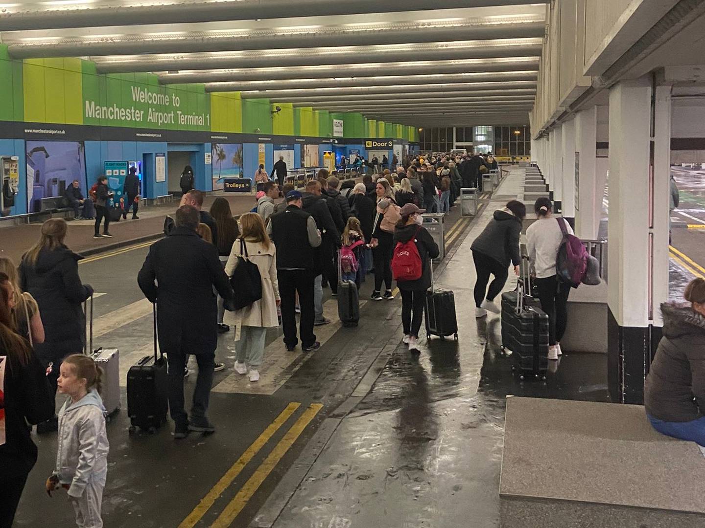 Passengers queue outside a terminal at Manchester Airport on Tuesday morning. Photo: Twitter