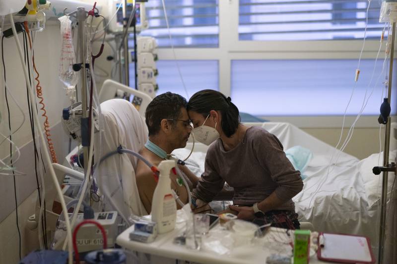 Amelie and Ludo Khayat hold each other during a visit at the Covid-19 unit of Marseille University Hospital Timone, in Marseille, southern France.  Ludo, 41, is recovering after spending 24 days in a coma. AP Photo
