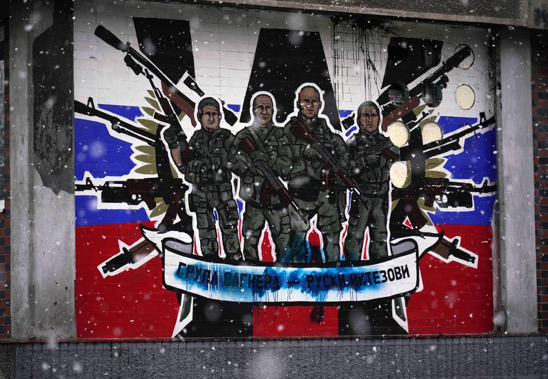 A defaced mural in Belgrade glorifies Russia's mercenary group, reading: Wagner Group - Russian knights. AFP