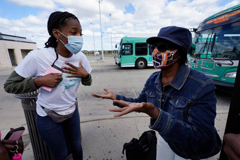 Wendy Caldwell-Liddell, left, who helped start Mobilize Detroit, a newly formed grassroots organization, talks to Margaret Roberts about voting in Detroit, Friday, September 18, 2020. Both President Donald Trump and Democratic presidential nominee Joe Biden are battling for support among Black voters across Michigan. AP Photo