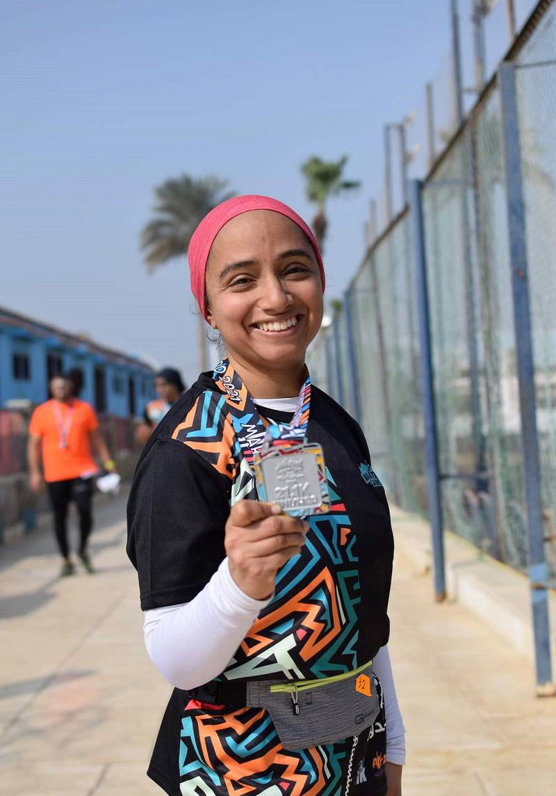 Aya Ayman with her half marathon medal. Courtesy Marathon Cairo
