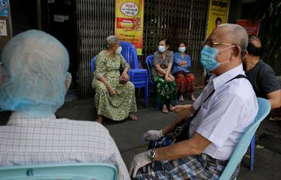 Elderly people wait to cast their ballots during early voting at a polling station in Yangon. EPA