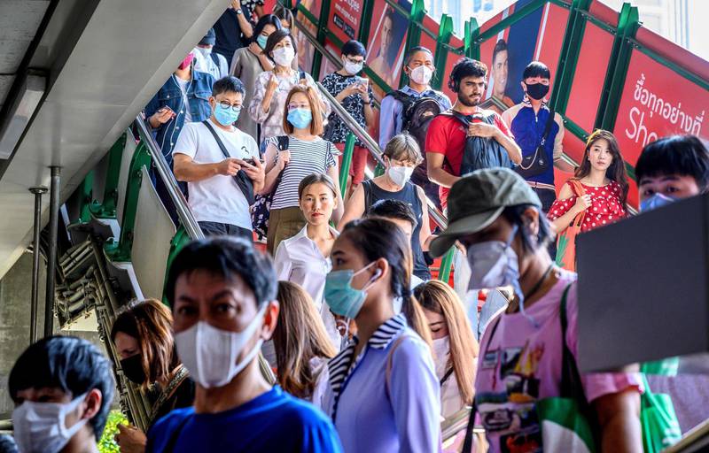 People with face masks arrive at a BTS Sky train station in Bangkok. Thailand has detected eight Coronavirus cases so far -- three of whom are receiving treatment in hospital and five of whom have been discharged, according to a statement from Health Minister Anutin Charnvirakul.  AFP
