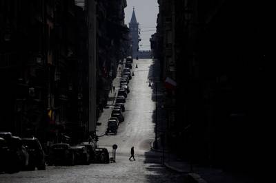 A man walks along a road leading to St. Mary Major Basilica, silhouetted in background, in Rome. AP Photo