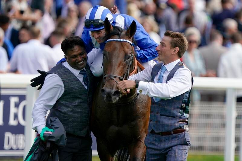 Stable lads congratulate Jim Crowley after he rides Baaeed to victory in the Juddmonte International Stakes at York Racecourse on August 17, 2022. Getty