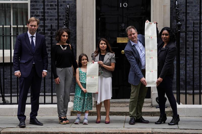 MP Tobias Ellwood, Gabriella Ratcliffe, MP Tulip Siddiq, Richard Ratcliffe and supporters hand in a petition to 10 Downing Street. PA