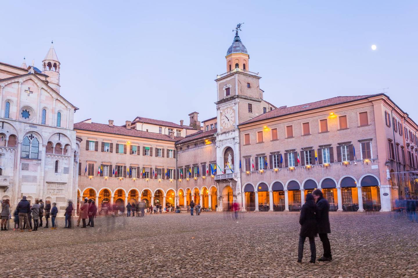 Modena, Piazza Grande, Emilia Romagna. Italy. Sunset with the town Hall illuminated and cathedral and La Bonissima statue. Getty Images