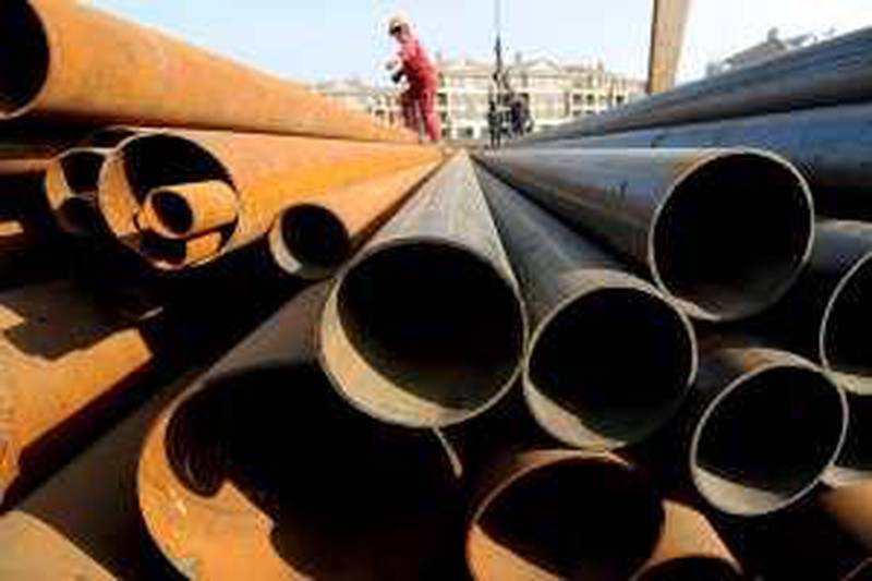 A labourer walks on steel pipes at a steel market in Hefei, Anhui province December 31, 2009. China on Thursday decried a U.S. decision to impose duties of 10 to 16 percent on Chinese-made steel pipe, the biggest U.S. trade case to date against China, and said it had been made a scapegoat of protectionist interests.    REUTERS/Stringer (CHINA - Tags: BUSINESS POLITICS) *** Local Caption ***  PEK03_CHINA-USA-TRA_1231_11.JPG *** Local Caption ***  PEK03_CHINA-USA-TRA_1231_11.JPG