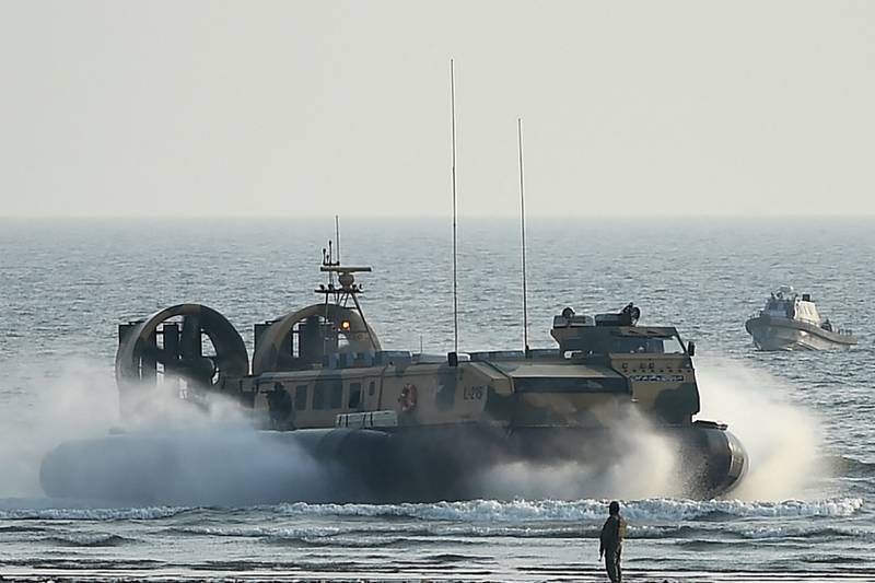 Pakistani marines take part in a drill off the beach in Karachi during the event. AFP