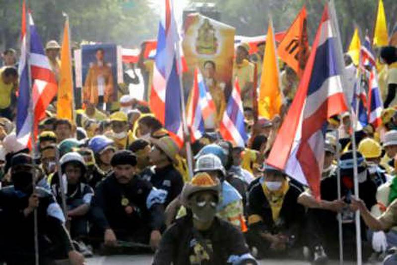 Thai anti-government protesters set up a human roadblock on a road leading to parliament during a mass rally in Bangkok, Thailand Monday, Nov. 24, 2008. Thousands of anti-government protesters surrounded Thailand's Parliament on Monday, forcing legislators to postpone a joint session, while more demonstrators rallied at other government offices in an action billed as their final bid to oust the administration. (AP Photo/Apichart Weerawong) *** Local Caption ***  AW106_Thailand_Political_Unrest.jpg