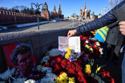 On February 27, the seventh anniversary of the assassination of opposition leader Boris Nemtsov, a note stating ‘No to war!’ is placed among flowers on the central Moscow bridge on which he was shot. AFP