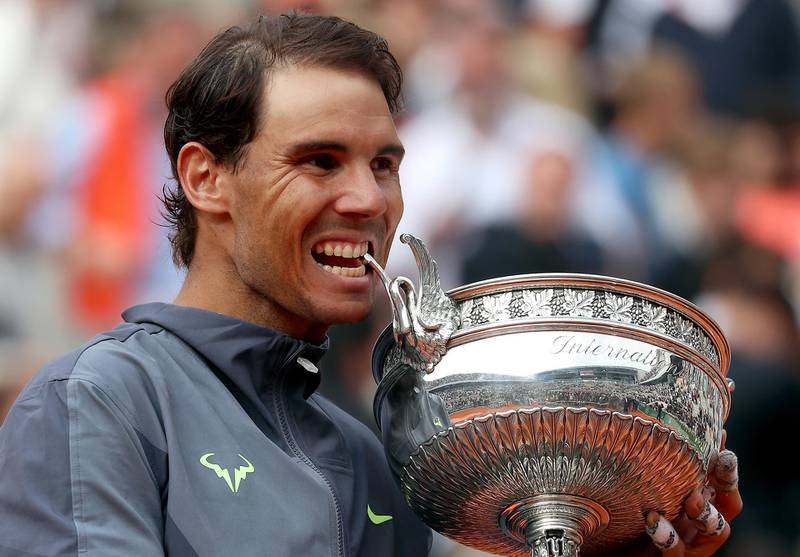 epa07637541 Rafael Nadal of Spain poses with the trophy after winning the men’s final match against Dominic Thiem of Austria during the French Open tennis tournament at Roland Garros in Paris, France, 09 June 2019. Nadal won the French Open title 12th times.  EPA/SRDJAN SUKI