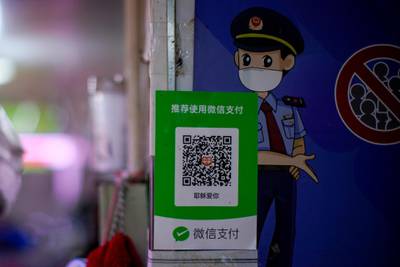 A shop in Shanghai, China displays the QR code of the WeChat Pay service as digital payments become more popular because of the pandemic. Reuters