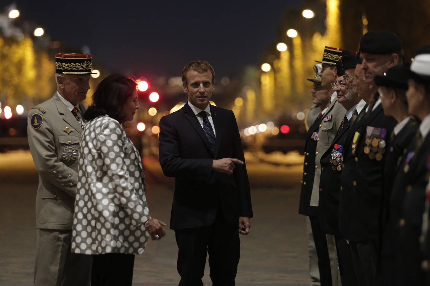 President Emmanuel Macron meet veterans during a ceremony near the Arc de Triomphe. AP