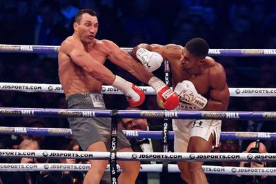 Britain's Anthony Joshua, right, throws a punch at Ukraine's Wladimir Klitschko during the fourth round of their IBF, IBO and WBA, world Heavyweight title fight at Wembley Stadium in London.  Ben Stansall / AFP Photo / April 29, 2017