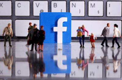 FILE PHOTO: A 3D printed Facebook logo is placed between small toy people figures in front of a keyboard in this illustration taken April 12, 2020. REUTERS/Dado Ruvic/Illustration/File Photo