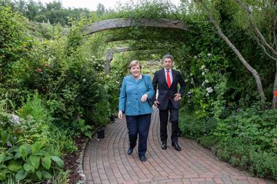 German Chancellor Angela Merkel and husband Joachim Saue attend a reception for the G7 leaders at the Eden Project in Cornwall. AP