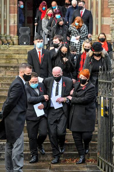 David Lewis, centre, husband to Gladys and father to Darren and Dean Lewis, is helped out of church by mourners during the funeral of Gladys, Dean and Darren Lewis at St Peter's Church in Pentre, South Wales. Mrs Lewis and her two sons all died of Covid-19 within five days of each other. (Photo by Ben Birchall/PA Images via Getty Images)