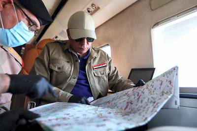 A handout picture released by the Iraqi prime minister's media office on June 2, 2020 shows Iraq's new premier, Mustafa Kadhimi (R), looking at a map with a member of the security apparatus aboard a plane the flew him to the restive northern city of Kirkuk for an official visit, one month after Islamic State group jihadists claimed a suicide attack that wounded four people outside an intelligence headquarters in the multi-ethnic city. (Photo by - / IRAQI PRIME MINISTER'S PRESS OFFICE / AFP) / === RESTRICTED TO EDITORIAL USE - MANDATORY CREDIT "AFP PHOTO / HO / IRAQI PRIME MINISTER'S PRESS OFFICE" - NO MARKETING NO ADVERTISING CAMPAIGNS - DISTRIBUTED AS A SERVICE TO CLIENTS ===