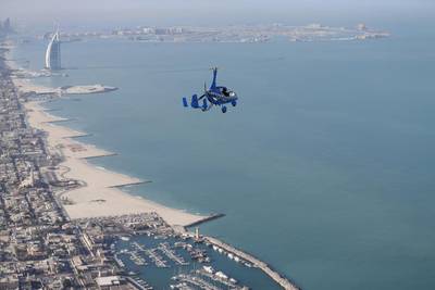A gyrocopter flies over Dubai during the World Air Games 2015 on December 9. Witnesses said a gyrocopter crashed into the sea off JBR on Wednesday. Karim Sahib / AFP Photo