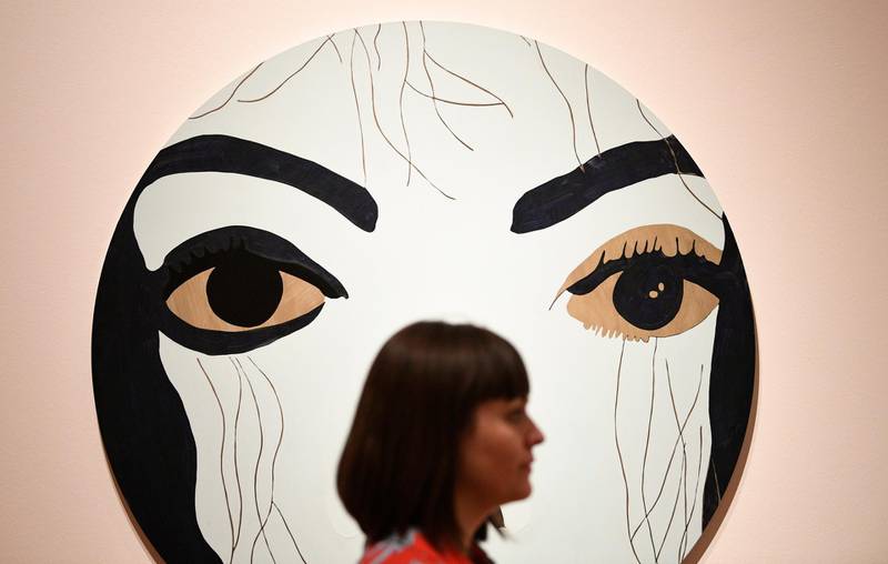 epa06843654 A woman stands near the Gary Holmes' work 'Michael' during a press preview of the exhibition "Michael Jackson: On the Wall" at the National Portrait Gallery in London, Britain, on June 27, 2018. Neil Hall / EPA