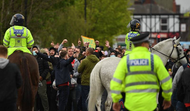 United fans clash with police outside of Old Trafford. AFP