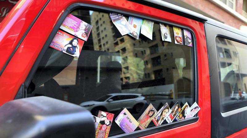 Massage cards are often placed on vehicles around city centres. Pawan Singh / The National