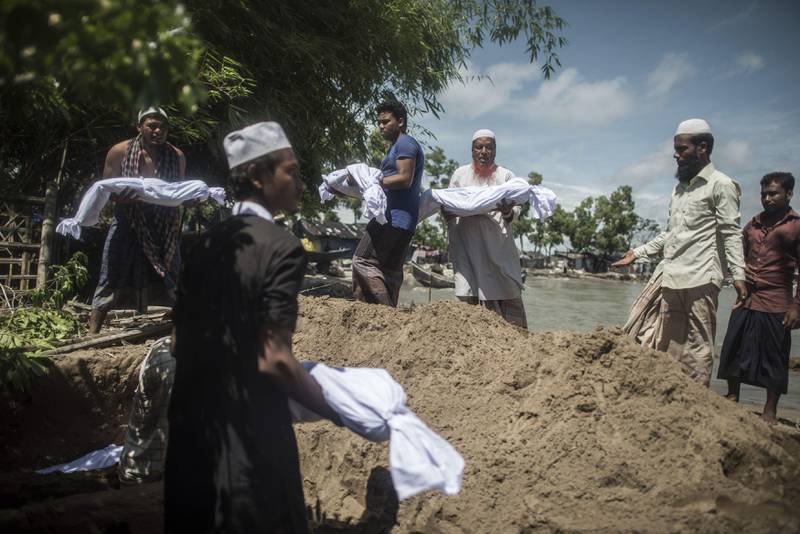 Bangladeshi people bury the bodies of Rohingya Muslim refugees at the pier of Shah Porir Dwip Island near Teknaf. Fred Dufour / AFP