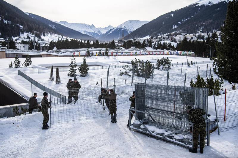 Soldiers of the Swiss Army set up fences around the congress centre.  EPA