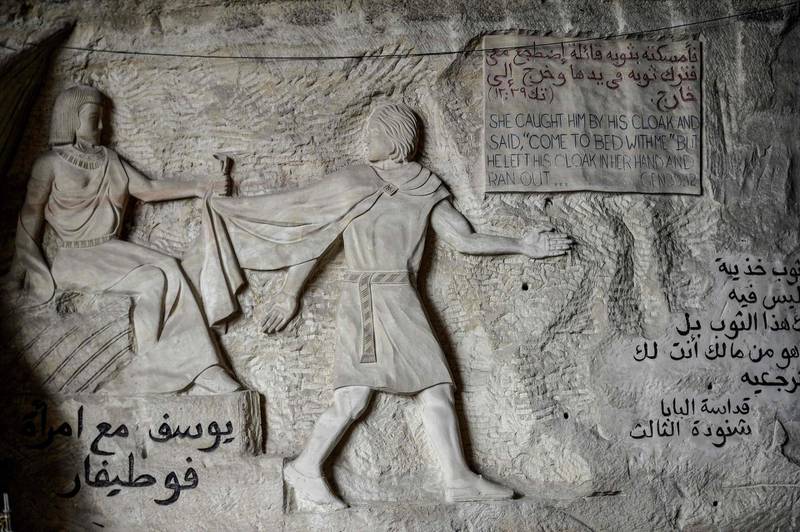 This picture taken shows a view of a relief sculpture made by Polish artist Mario at the St. Simon the Tanner Monastery complex in the Egyptian capital Cairo's eastern hillside Mokattam district, depicting the attempted seduction of the Old Testament Biblical prophet Joseph by the wife of Potiphar according to the Book of Genesis. Mario spent more than two decades carving the rugged insides of the seven cave churches and chapels of the rock-hewn St. Simon Monastery and church complex atop Cairo's Mokattam hills, with designs inspired by biblical stories. It was all done to fulfil the wishes of the church's parish priest who met Mario in the early 1990s in Cairo. The Polish artist, who had arrived in Egypt earlier on an educational mission, was then looking for an opportunity to serve God at the monastery. AFP