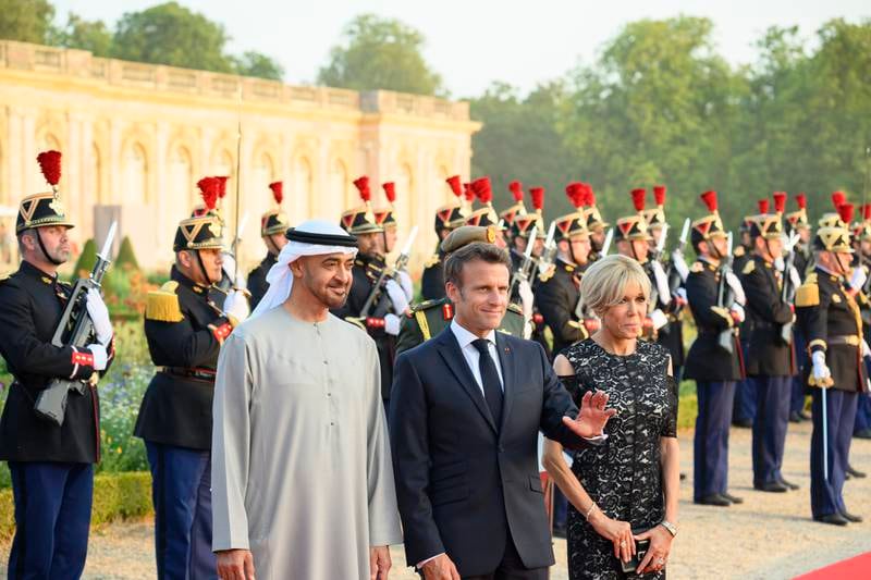 Sheikh Mohamed, Mr Macron and France's first lady Brigitte Macron at the Versailles Grand Trianon.
