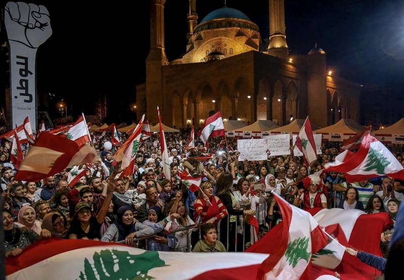 epa08022977 Lebanese protesters shout slogans and carry the national flags during an anti-government protest at Martyrs' square in Beirut, Lebanon, 24 November 2019. Protests in Lebanon are continuing since first erupted on 17 October, as protesters aim to apply pressure on the country's political leaders over what they view as a lack of progress following the resignation of Prime Minister Saad Hariri on 29 October.  EPA-EFE/NABIL MOUNZER *** Local Caption *** 55659324