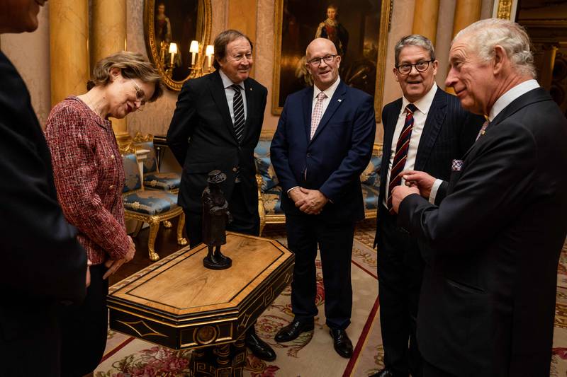 King Charles is presented with a maquette of Queen Elizabeth by South Australia Governor Frances Adamson and other Australian officials at Buckingham Palace. AFP