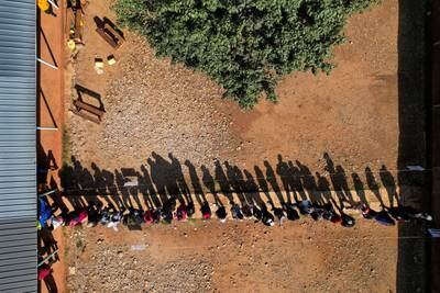 People in the Rift Valley town of Eldoret line up to cast their vote in Kenya's general election. Reuters
