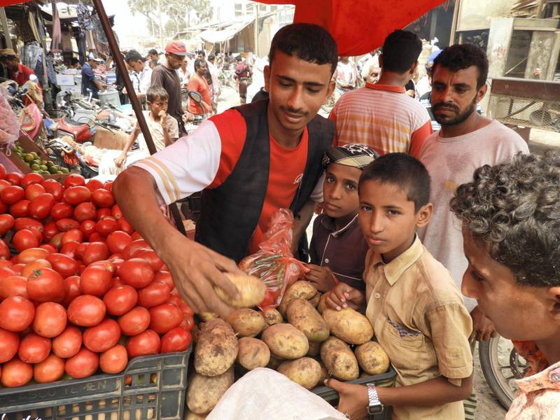 Children purchasing their daily needs in the public market amid the city of Al-Khoukhah. Ali Mahmood for The National